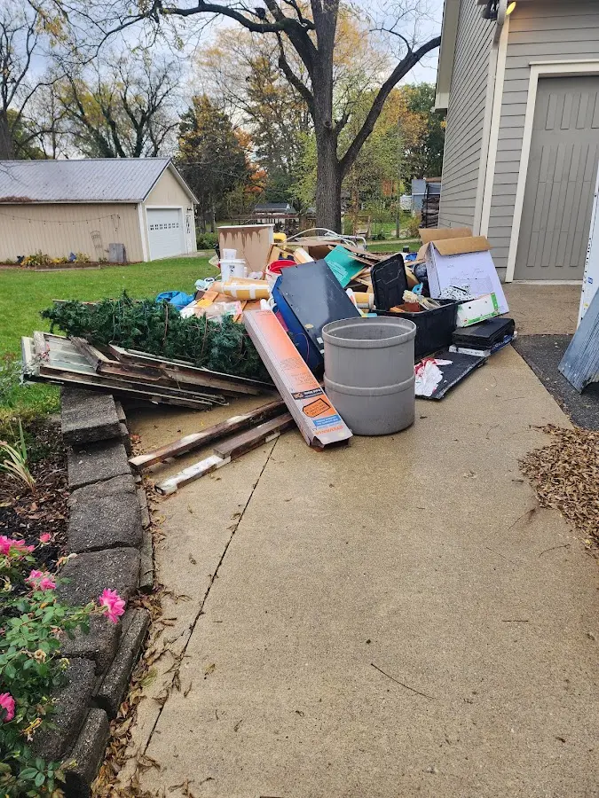 Dumpster being loaded with debris for 12 Yard Dumpster Rental in Hometown